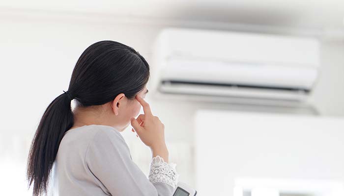 Girl looking at the air conditioner
