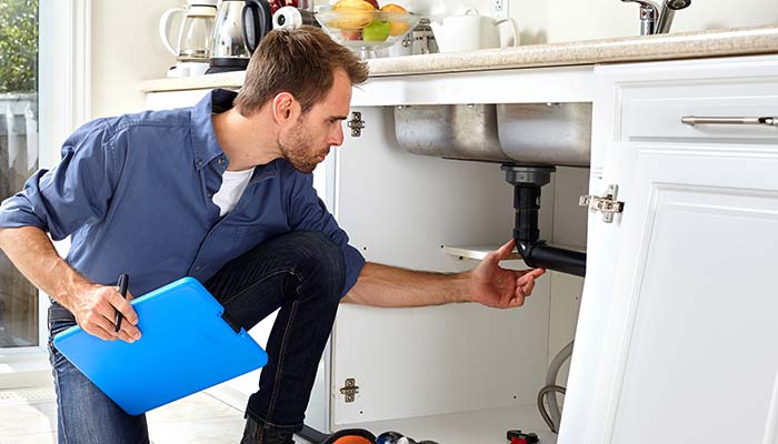 Man checking the sink pipe