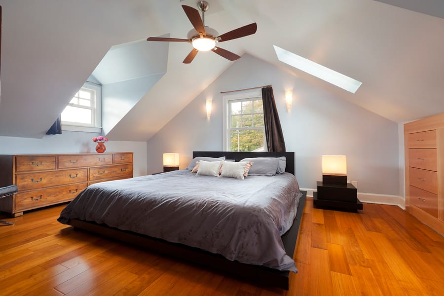 room with a ceiling fan and light in it