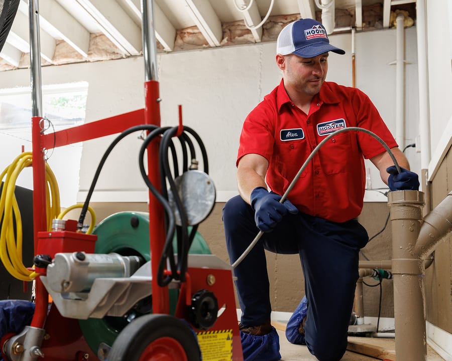 Plumbing conducting emergency plumbing service in basement