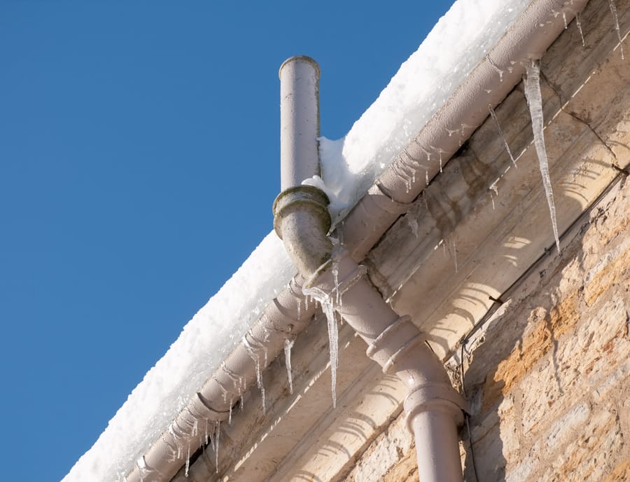 frozen pipes outside attached to gutter