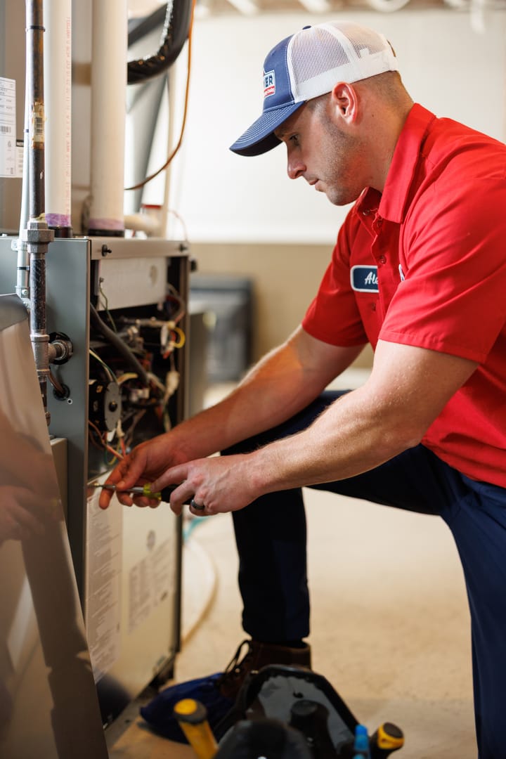 technician performing furnace repairs