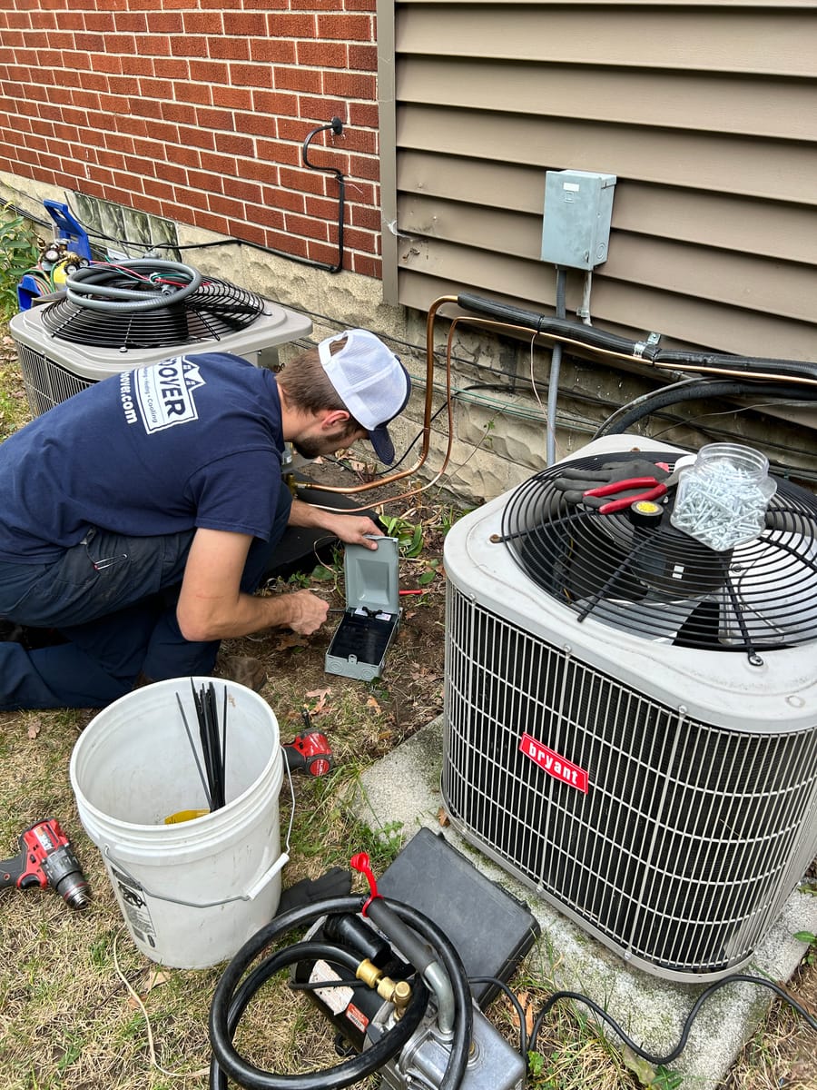 Man outside working on HVAC unit