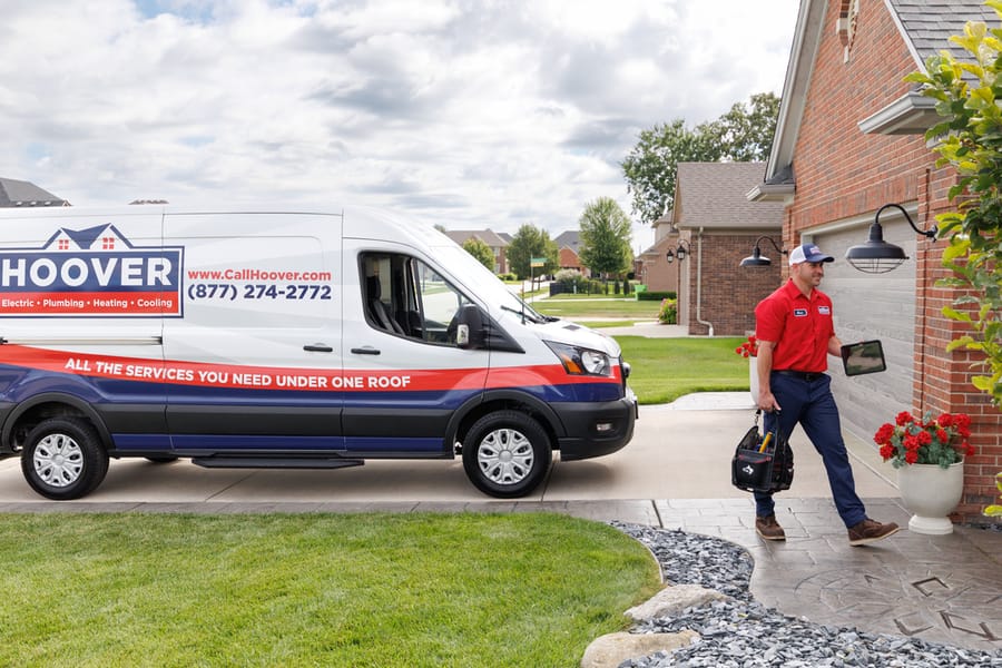 Hoover tech carrying tools into the house