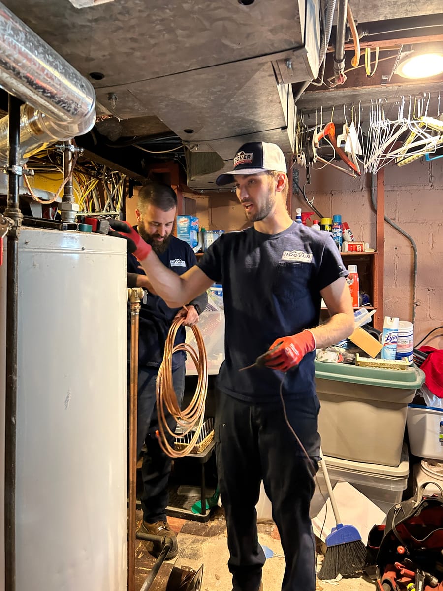 technician performing water heater installation
