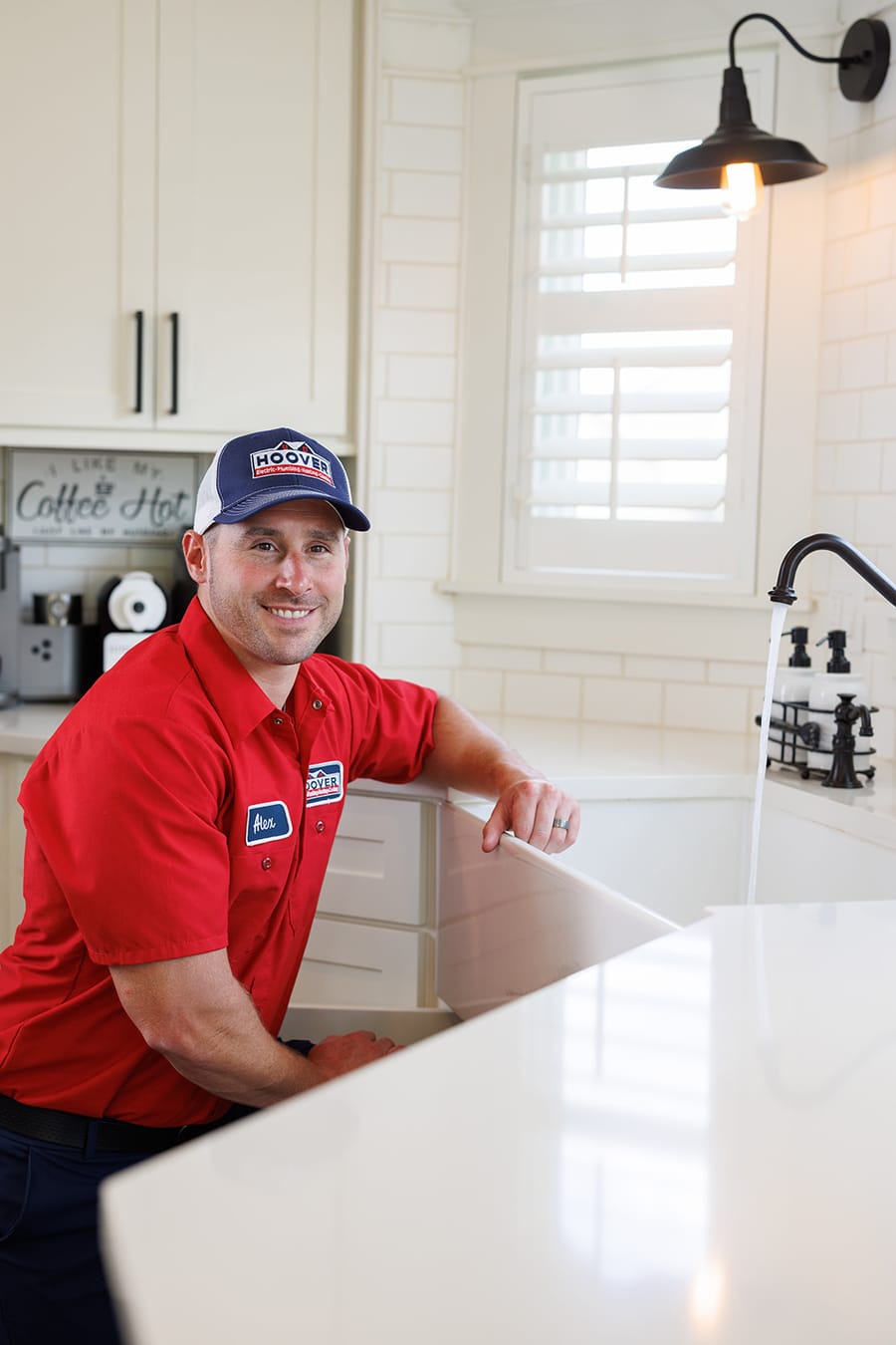 Hoover plumbing testing faucet during leak detection appointment