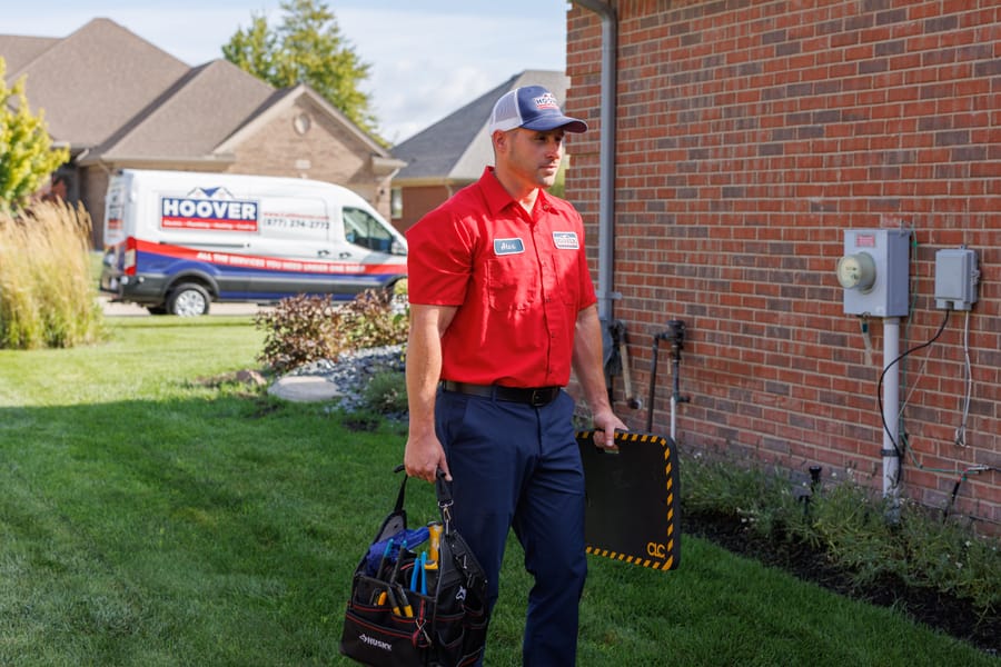 Hoover technician walking to go conduct home repairs