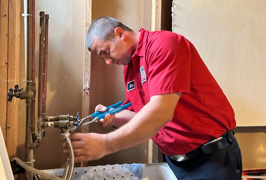 man fixing plumbing