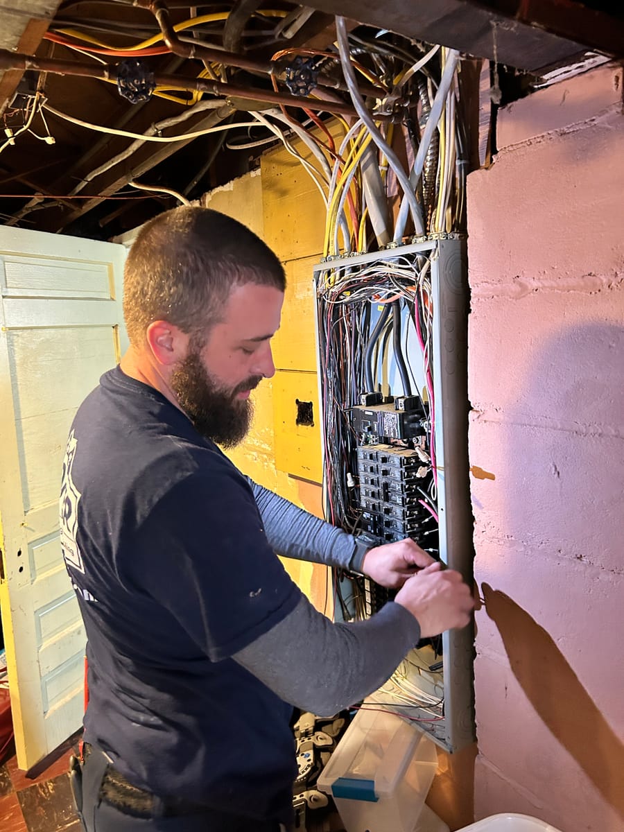 Electrician working on electric panel